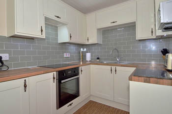 Fully equipped kitchen with electric fan oven, induction hob and microwave